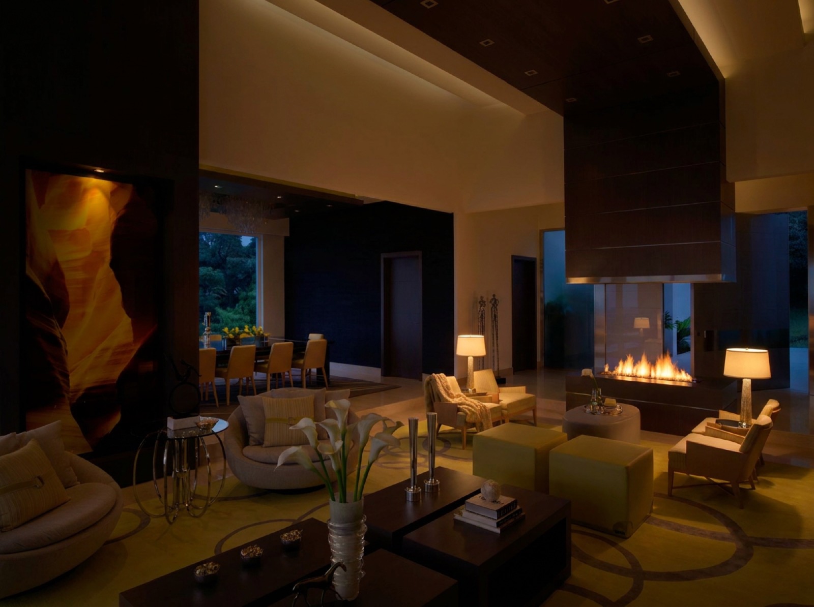 The same living and dining space lit with the warm dim layer only