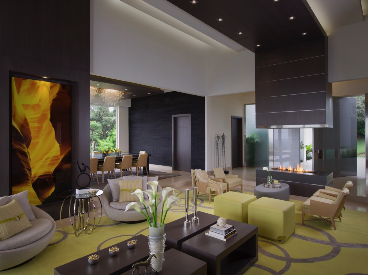Open-plan living and dining space with layered architectural lighting